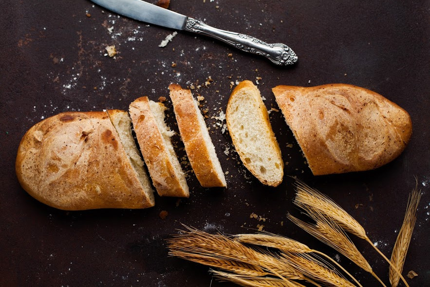 Wheat, knife, and bread on the table